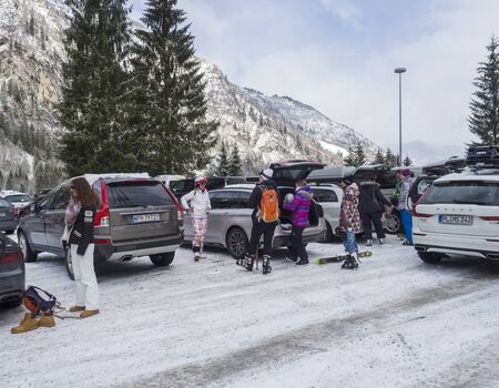 KAPRUN, AUSTRIA, March 12, 2019: Skiers are getting out from cars at parking place at Kitzsteinhorn ski resort and make preparations to up to Cable car ski lift on top of the glacier.のeditorial素材