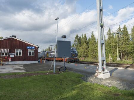 Murjek, Norrbotten, Sweden, Agust 22, 2019: Old red bulding of Train station at Murjek with goods...