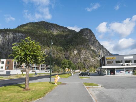 Valldal, Norway, September 7, 2019: Main road in village Valldal, Norddal with Bunnpris supermarket and adventure center. High cliffs, mountains and forest, Valldalen valley and summer blue sky.のeditorial素材