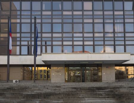 CZECH REPUBLIC, Prague, November 18, 2019: glass facade and entrance of Building of Ministry of the Interior of the Czech Republic, in Czech: Ministerstvo vnitra with czech and EU flag.のeditorial素材