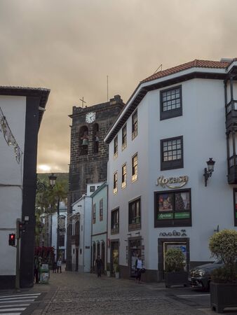 Santa Cruz de la Palma, La Palma, Canary Islands, Spain, December 30, 2019: Street at Santa Cruz old city center with tourist people, bell tower of chuch Iglesia El Salvadorand, christmas decorations.のeditorial素材