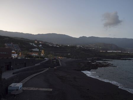 Los Cancajos, La Palma, Canary Islands, Spain, December 23, 2019: Night evening view on black beach and promenade along the beach with restaurants, shops and christmas decorationsのeditorial素材
