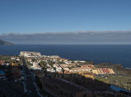 Los Cancajos, La Palma, Canary Islands, Spain, December 22, 2019: view from viewpoint Mirador de Risco Alto on village Los Cancajos, ocean and green hills. Blue sky backgroundのeditorial素材