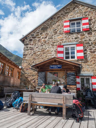 Stubai Valley, Innsbruck-Land, Tyrol, Austria, July 4, 2020: hiker people resting at terrace of Nuernberger Huette, an alpine mountian hut at sunny summer dayのeditorial素材