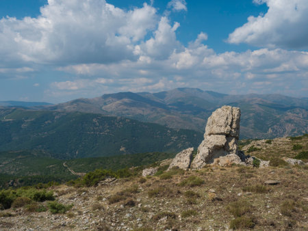 View from white limestone tower Perda Liana, impressive rock boulders, green forest hill and mountain. National Park of Barbagia, Central Sardinia, Italy, summer dayの写真素材