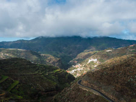 View of Beautiful Gran Canaria inland central mountains and green hills with winding asphalt road. Canary island, Spainの写真素材