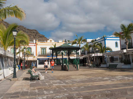 Puerto de Mogan, Gran Canaria, Canary Islands, Spain December 18, 2020: Main square and colorful buildings of small fishing village port, favorite tourist place.のeditorial素材