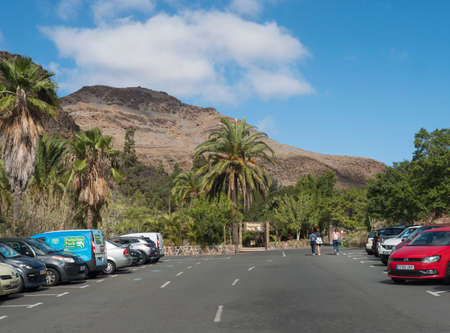 San Bartolome de Tirajana, Gran Canaria, Canary Islands, Spain December 18, 2020: Cars and parking lot at entrance to Zoo Palmitos park with three tourist woman, sunny dayのeditorial素材