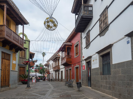Teror, Gran Canaria, Canary Islands, Spain December 21, 2020: Street of beautiful historic town Teror with colorful facades, houses with traditional wooden balcony, colonial architectureのeditorial素材
