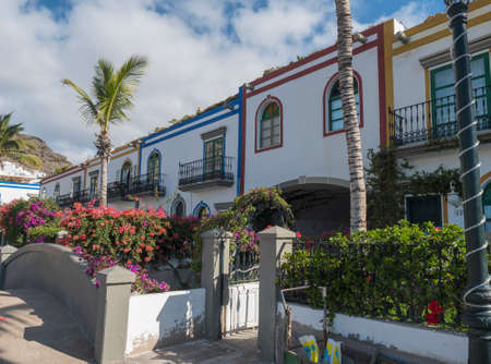 Puerto de Mogan, Gran Canaria, Canary Islands, Spain December 18, 2020: Traditional colorful houses at pedestrian street of small fishing village port Puerto de Mogan, favorite tourist place.のeditorial素材