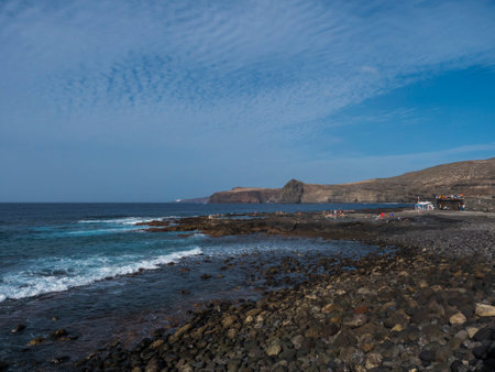 Puerto de las Nieves, Agaete, Gran Canaria, Canary Islands, Spain December 17, 2020: Natural sea pool Las Salinas de Agaete with group of relaxing people and coastal cliffs.のeditorial素材