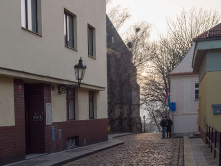 Czech Republic, Prague, February 23, 2021: late afternoon view of Apolinarska street at Prague center with young people coupleのeditorial素材