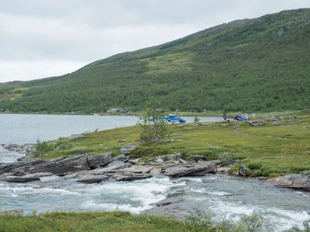 Staloluokta, Norrbotten, Sweden, Agust 11, 2021: Two Fiskeflyg helicopters with tourist and supplies landing at sami village Staloluokta at Virihaure lake, summer foggy day. Padjelanta Laplandのeditorial素材