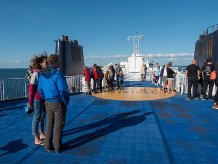 Rodbyhavn, Denmark, Agust 21, 2021: People enjoying the cruise and sun on the deck of the Scandlines...
