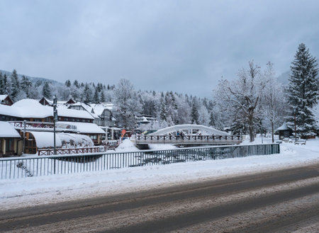 Spindleruv Mlyn, Czech republic, December 5, 2021: Winter view of snow-covered Spindleruv Mlyn street, popular tourist destination, mountain and ski resort. Cloudy dayのeditorial素材