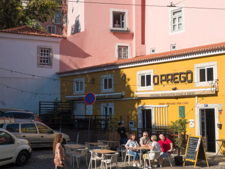 Lisbon, Portugal, October 24, 2021: View of yellow building of restaurant Oprego at medieval quarter...