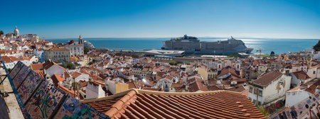 Lisbon, Portugal, October 24, 2021: Aerial panoramic view of Lisbon skyline, rooftops and tejo river in Portugal seen from the viewpoint called Miradouro das Portas do Sol at Alfama old town districtのeditorial素材