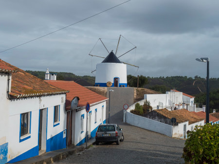 Odeceixe, Odemira, Portugal, October 28, 2021: Paved street at village Odeceixe with historic blue white portuguese windmillのeditorial素材