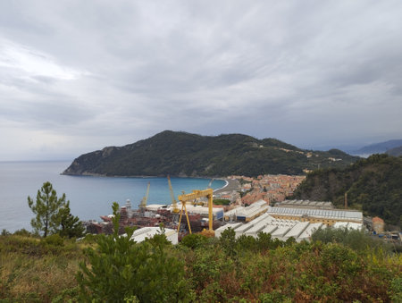 Panoramic aerial view on Riva Trigoso village from Punta Bafe, sand beach, houses, shipyard and Punta Manara bay at cloudy autumn day. Sestri Levante, Liguria, Italyのeditorial素材