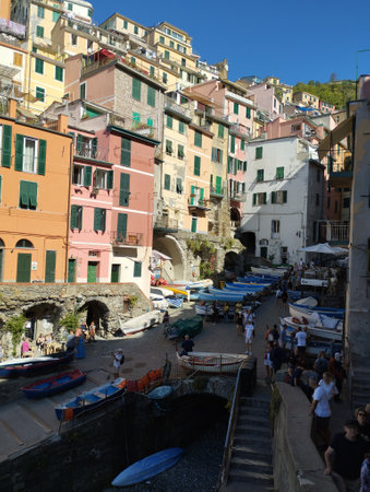 Riomaggiore, Cinque Terre, Liguria, Italy, September 25, 2023: Old harbor of Riomaggiore with wooden boats and historical buildings, colorful tower houses, crowded with tourist peopleのeditorial素材