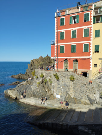 Riomaggiore, Cinque Terre, Liguria, Italy, September 25, 2023: Old harbor of Riomaggiore with wooden boats and historical buildings, colorful tower houses, crowded with tourist peopleのeditorial素材