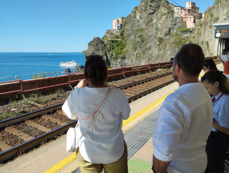 Riomaggiore, Cinque Terre, Liguria, Italy, September 25, 2023: View from platform of train station in Riomaggiore, with sea, ship and tourist peopleのeditorial素材