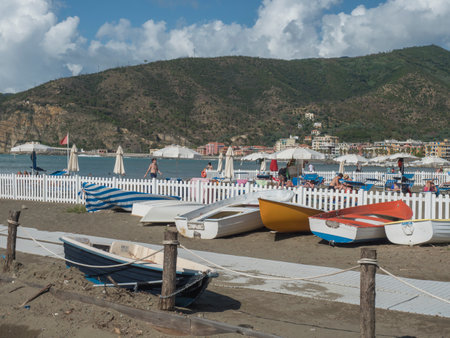 Sestri Levante, Liguria, Italy, September 23, 2023: Seaside with colorful wooden fishing boats and people sunbathing at sand beach Bagni Liguria at Sestri Levante, Italy Europeのeditorial素材