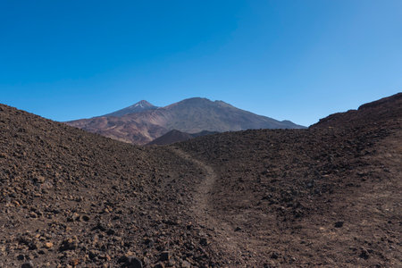 View on colorful volcano Pico del Teide from hiking trail Samara. Mountains and lava fields against blue sky. El Teide National Park, Tenerife, Canary Islands, Spainの写真素材