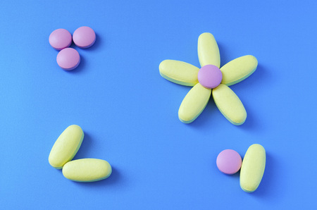 colored tablets in the shape of a flowerの写真素材