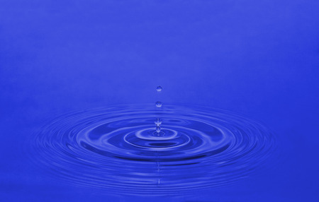 a drop of water on a blue backgroundの写真素材