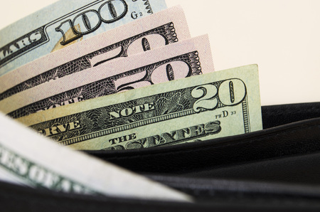American dollars are partially visible with a purseの写真素材