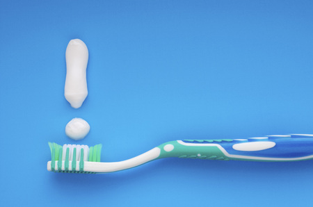 toothpaste and brush on a blue backgroundの写真素材