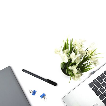 Flat lay, top view office table desk. Workspace with keyboard, office supplies, pen, potted plants, and notebook on white background 2の写真素材