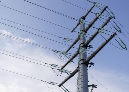 Pillar and power lines against a cloudy sky 2の写真素材