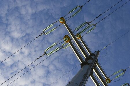 Pillar and power lines against a cloudy sky 2