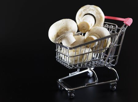 champignon mushrooms in a trolley on a black background 3の写真素材