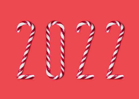 2022 made from sweet caramel canes, candies on red backgroundの写真素材