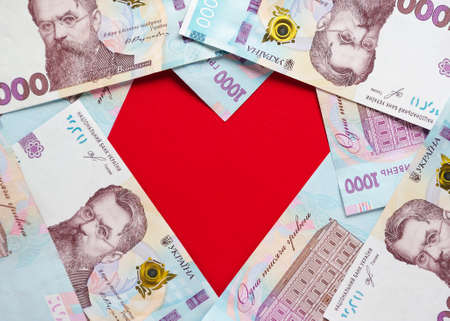 A heart lined with Ukrainian hryvnia banknotesの写真素材