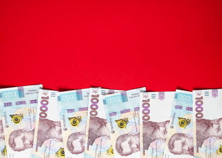 One thousand Ukrainian hryvnia banknotes on a red background 4の写真素材