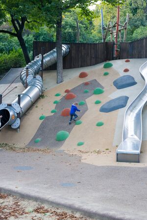Modern outdoor playground with slides and climbing frames