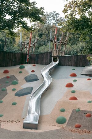 Modern outdoor playground with slides and climbing frames