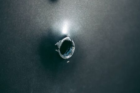 Bullet hole on a metal sheetの写真素材