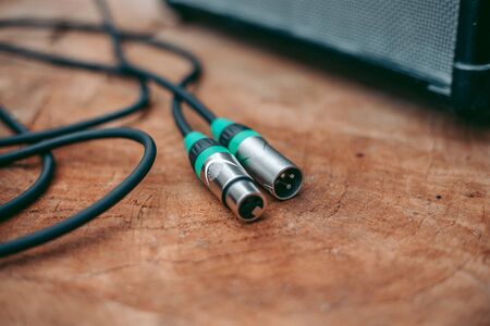 Green xlr cable on the wooden tableの写真素材