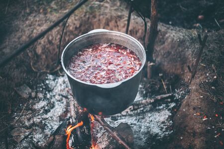 Cauldron with soup on a campfire in a hikeの写真素材
