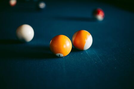Multi-colored billiard balls on a blue table