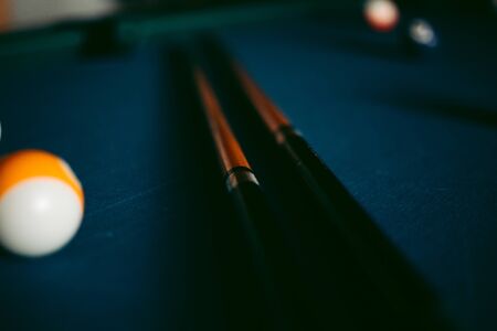 Multi-colored billiard balls on a blue table