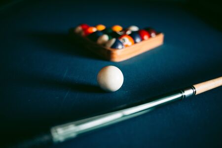 Multi-colored billiard balls on a blue tableの写真素材