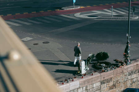 A man crosses a road at a pedestrian crossingのeditorial素材