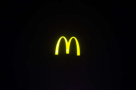 Yellow mcdonalds sign at night on the streetのeditorial素材