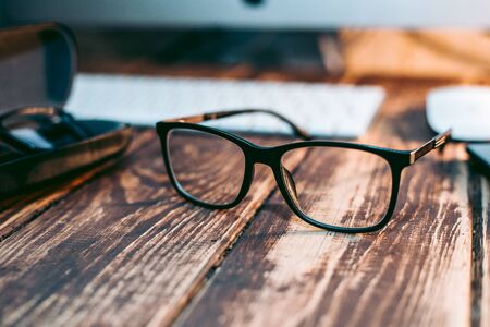 Glasses for sight and vision correction and protection from computer on the wooden tableの写真素材